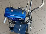 a small blue machine sitting on the floor in a room