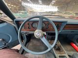 a steering wheel and dashboard of a car inside of a building