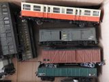 a lot of toy trains in a box on the table