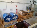 two blue barrels sitting on a pallet in a room