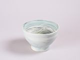 a white bowl with a blue and green design on it