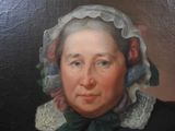 portrait of a woman in a bonnet and a black dress