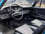 a blue car with black leather seats and a steering wheel