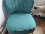 a blue chair that is sitting in the corner of a room