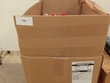 a cardboard box sitting on a pallet in the middle of a room
