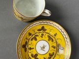 a close up of a cup and saucer on a table