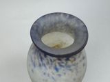 a blue and white vase sitting on a white surface