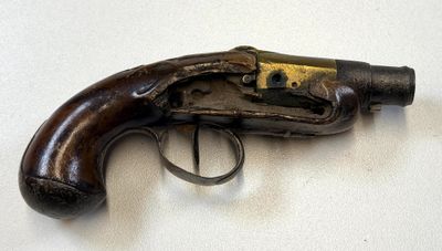 an old gun on a table with a ring on it