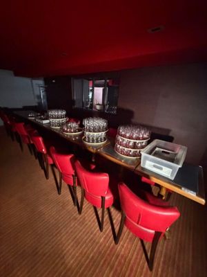 a long table with many glasses on it in a room