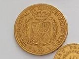 three different types of gold coins on a white surface
