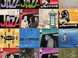 various jazz albums and records on a wall in a room