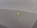 a yellow arrow points to the side of a gray car
