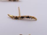 three pairs of gold earrings with black and white stones