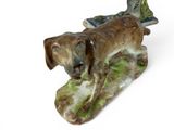 a figurine of a dog on a skateboard on a white surface