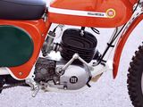 a red motorcycle parked on the street with a black seat