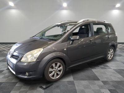 a picture of a grey car parked in a garage