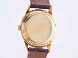 an image of a close up of a watch on a white surface