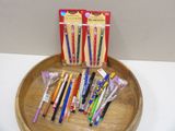 a wooden tray holding a variety of pens and pencils