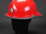 a close up of a red hard hat on a mannequin head