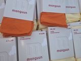 boxes of orange and white men ' s underwear stacked on top of each other