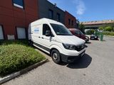 a white van parked in a parking lot next to a building