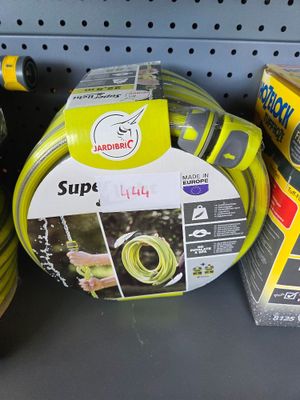 several different types of garden hoses are on display in a store