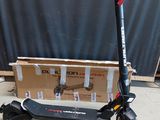a scooter that is sitting in front of a box