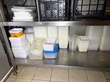 many containers and containers on the shelf in the kitchen