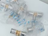 several silver and gold valves on a white table with a price tag