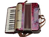 an image of a red and white accordion sitting on top of a table