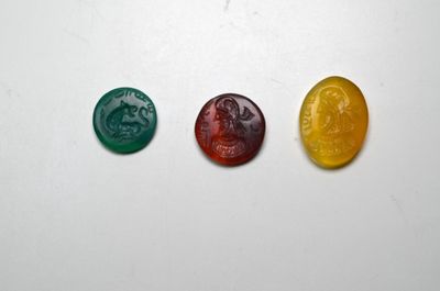 trois oursons en gélatine de couleurs différentes, assis les uns à côté des autres sur une surface blanche