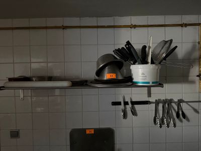 a kitchen with a lot of utensils on the shelves