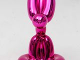 a close up of a shiny pink object on a white surface