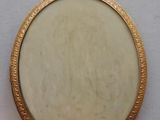 an image of a gold locke with a picture of a woman on it