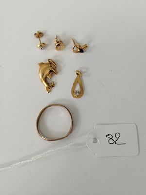 two pairs of gold rings and a gold ring on a white surface