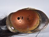 a brown helmet with black hair on top of it