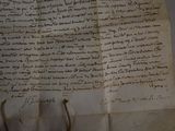 an old document with writing on it sitting on top of a table