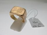 a gold ring that has a small tag on it