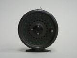 a close up of a fly fishing reel on a stand
