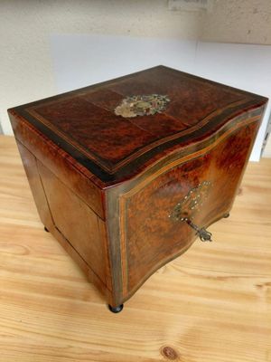a small wooden box sitting on a wooden table