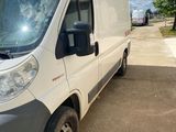 the white van is parked on the side of the road
