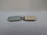 two small toy trains sitting on a white surface