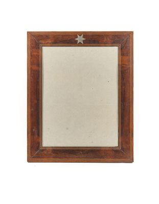 a small wooden frame with a star on it