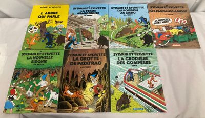 quatre livres pour enfants posés sur un lit recouvert d'un drap blanc