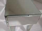a glass table with a mirror on top of it