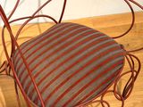 a red chair with a striped cushion on it