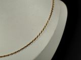 an image of a gold chain necklace on a mannequin