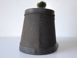 a small pot with a small cactus on top of it