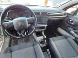 the interior of a small car with a steering wheel and dashboard