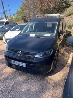 a black van parked in a parking lot next to other cars